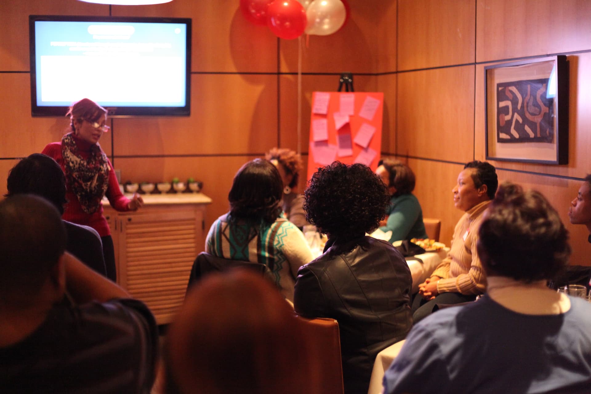 Janette R. Smith facilitating a group discussion in a room of participants